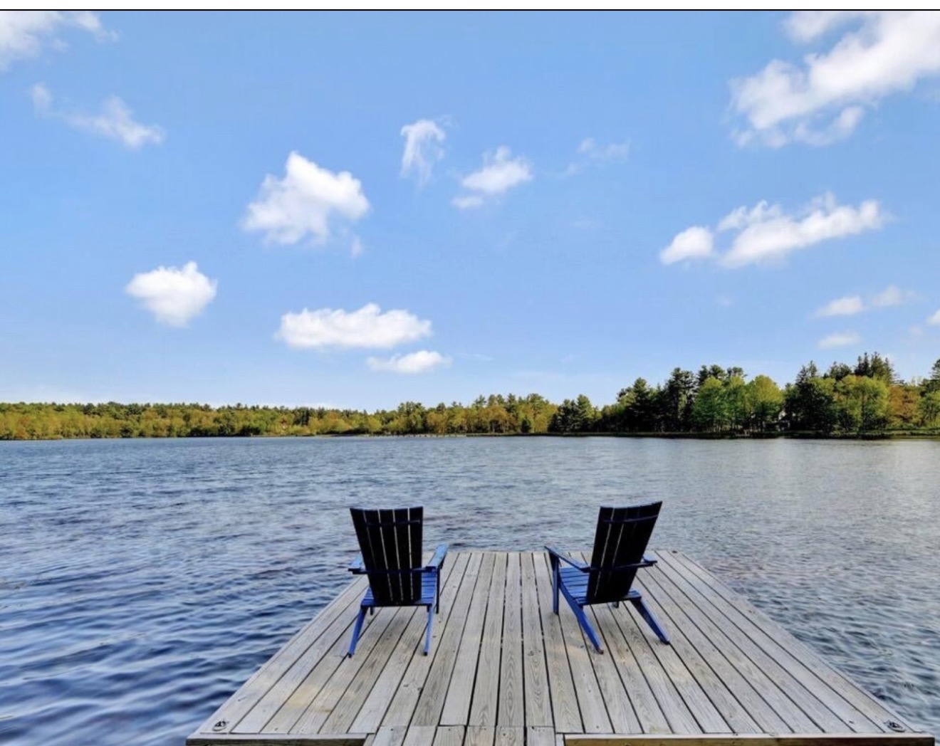 Adirondack chairs on a private dock